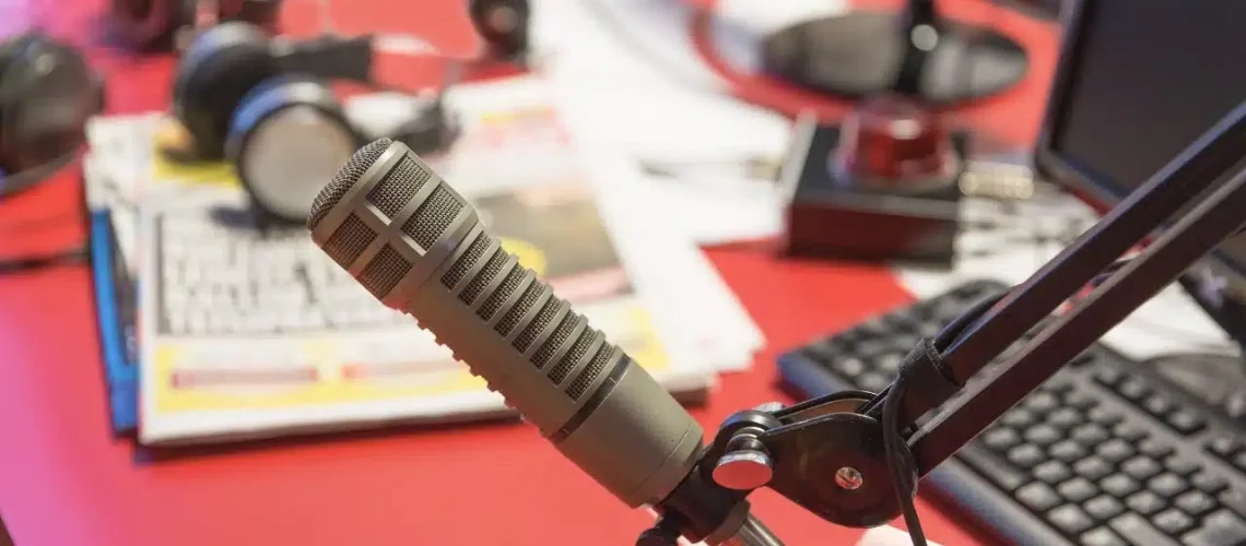 Microphone et équipement de podcast avec en arrière-plan une carte des Antilles Guyane, symbolisant l'introduction au podcasting dans la région.